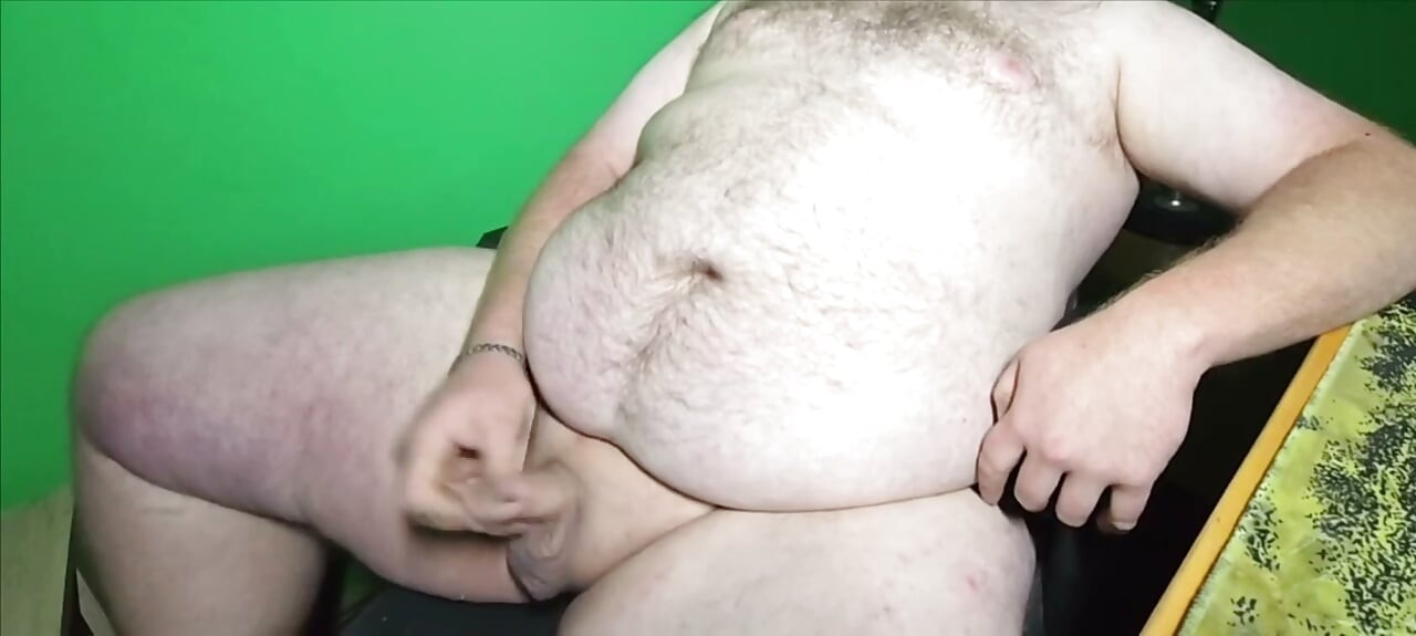 A fat boy with a small dick is masturbating.