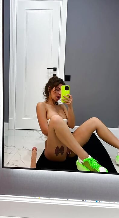 I'm sitting in front of the mirror, touching my pussy