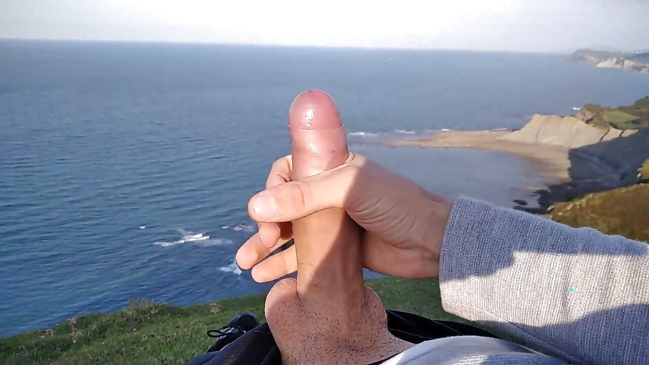 Huge Dirty Cock Gets Handjob on the Beach and Squirts a Lot of Thick Sperm in Front of the Beach
