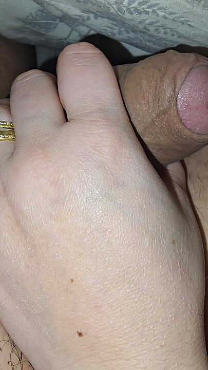 Hot step mom giving on her step son a handjob in bed