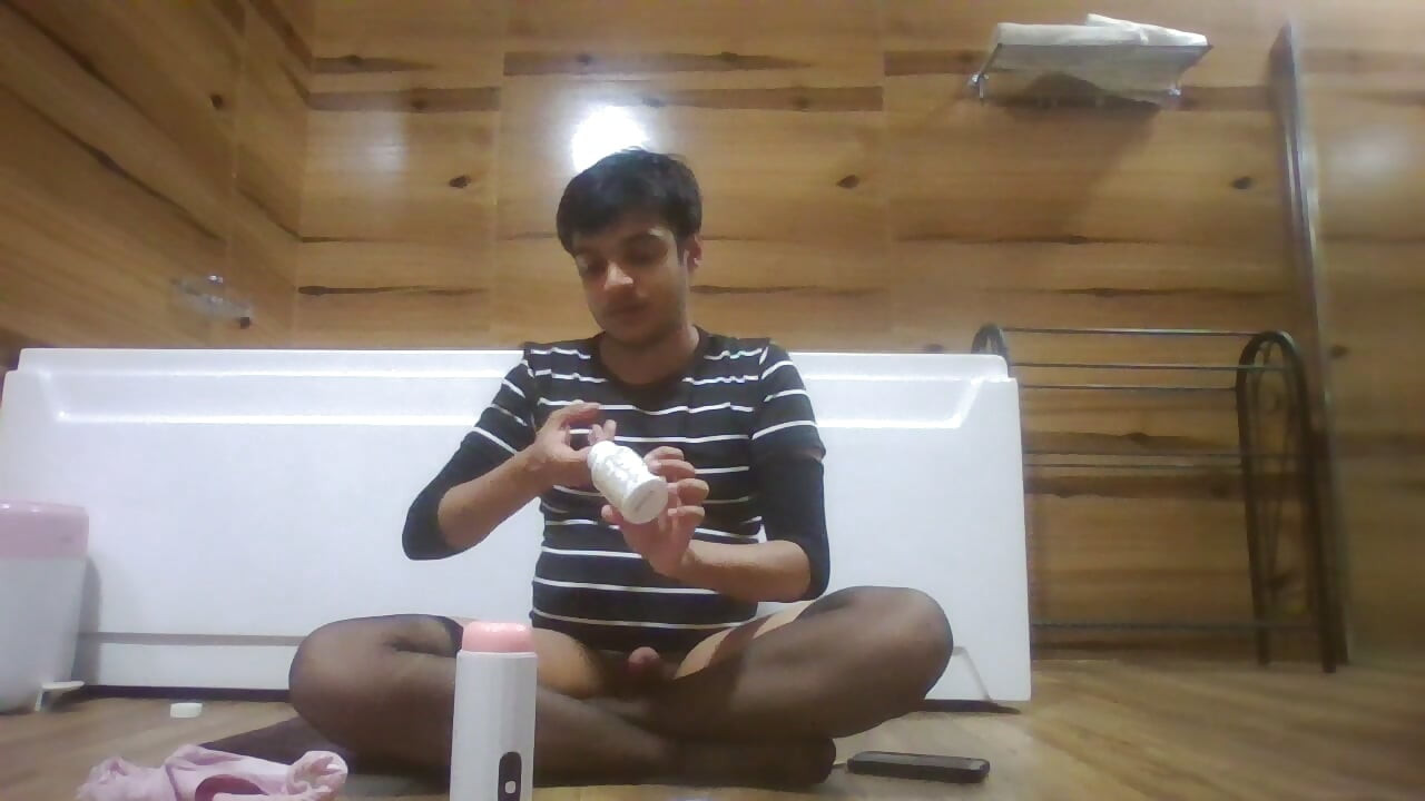 Sexy Sissy in Pantyhose Plays with Pocket Pussy while half naked and watching porn on her phone