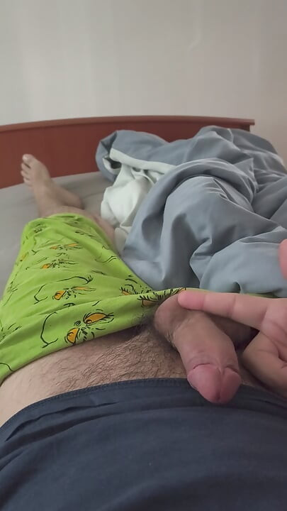 Cute handjob on the bed with a hard and erect penis