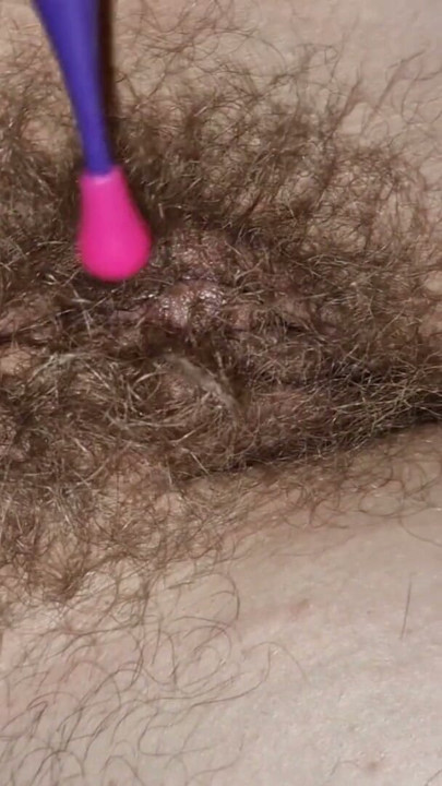 Wife's hairy wet cunt and pin point vibrator. Juice starts leaking from her cunt | Clip 1