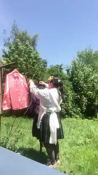 In planter's outfit, hanging laundry