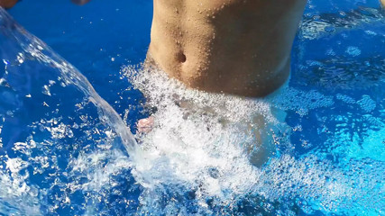 German Guy in the swimming pool enjoying the Waterfall