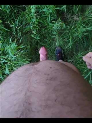 Naked outside under a bridge.