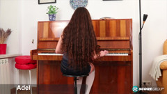 Adel, a cutie with long, flowing brunette hair, plays the