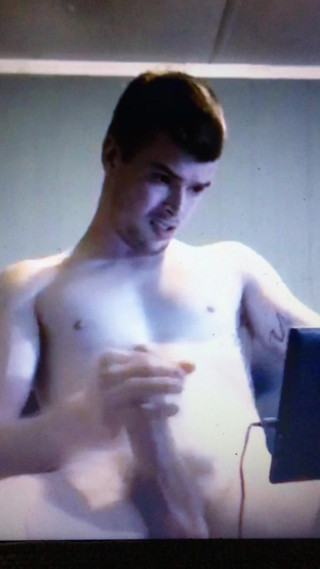 Young student jerking his huge cock whilst watching porn
