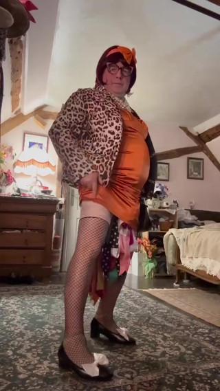 Dressed in a tight little orange dress for an evening thumbnail