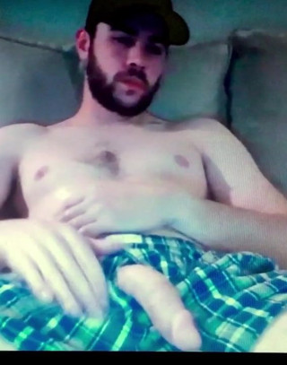 Bearded guy shows his huge hung flaccid cock in shorts