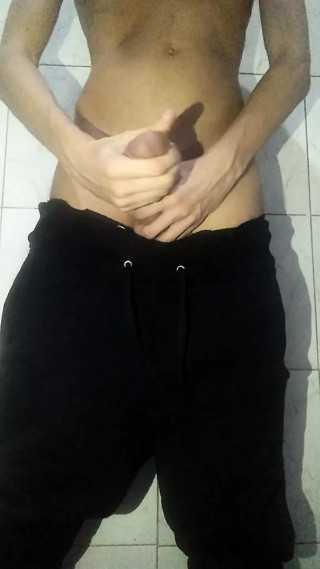 Young boy went to the bathroom, lowered his sweatpants and continued masturbating his big and thick shaved dick