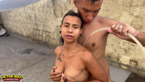 Young girl taking a hose bath in the backyard and dancing funk
