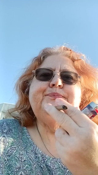 Bearded Lady try's to  lights  on windy beach!