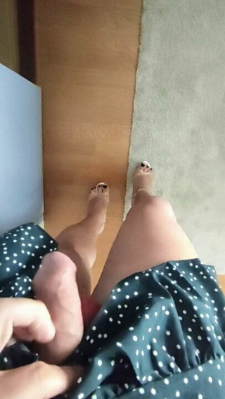 Joana looks at mirror showing legs, cock and heels,