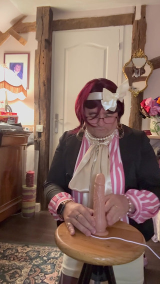 In an outfit with a little short skirt and a new blouse to suck a dildo at a party thumbnail