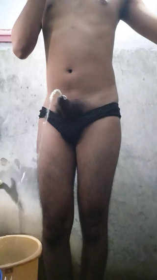 Teen Indian boy wearing black panty while pissing in the bathroom