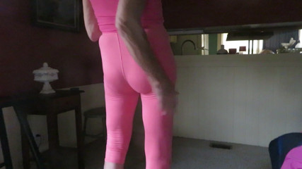 Crossdressing slut poses in skin-tight leggings.