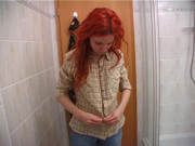 Redhead beauty showering solo
