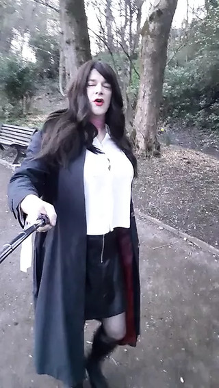 crossdresser wearing a short leather skirt walking in the park in Waterfoot Lancashire