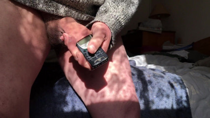 Foreskin in sun with: mobile phone