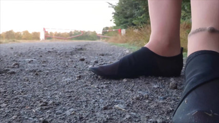 Bright Pantyhose and Beach Shoes in Puddle
