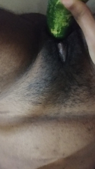Busty bitch playing with herself and fucking herself with a cucumber