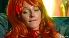Horny redhead Stella Bliss plays ionately with a dildo on the couch.