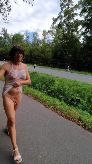 Naked under a mesh shirt on the street thumbnail