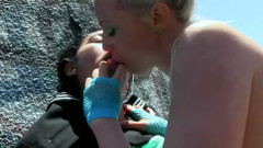 Tattooed Blonde and Her Girlfriend Lick Each Other Outdoors on the Rocks