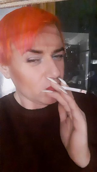 transvestite Sonyastar smokes, long nails, red hair