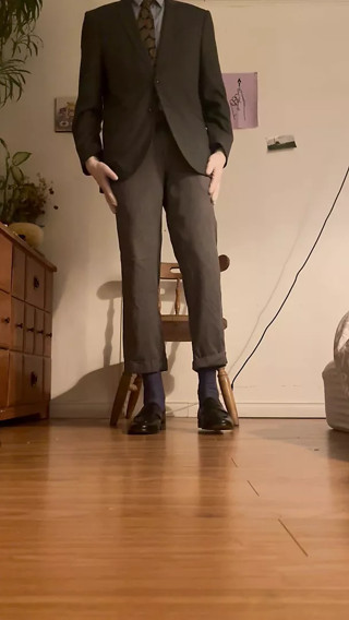 Rock hard suited guy dons white latex gloves