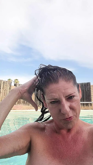 Naked swimming and smoking mature woman