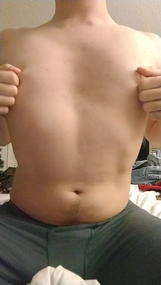 Shirtless twink playing with his nipples