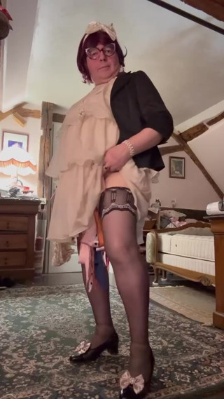 Dressed in a little cream-colored ruffled dress for an evening thumbnail
