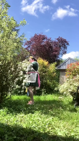 In a planter's outfit for pruning shrubs