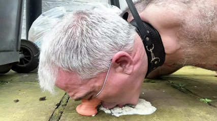Humiliated gay pig slave eats food off the filthy ground