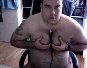 Fat fuck squeezing his tits jacking off