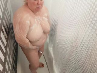 Mother-in-law takes a shower and washes her big tits