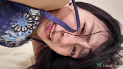 Japanese woman Mikoto Fujisaki plays with a sex toy in bed.