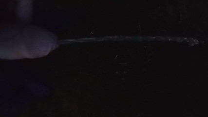 Boy pissing on highway parking lot