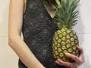 skinny girl playing with pineapple