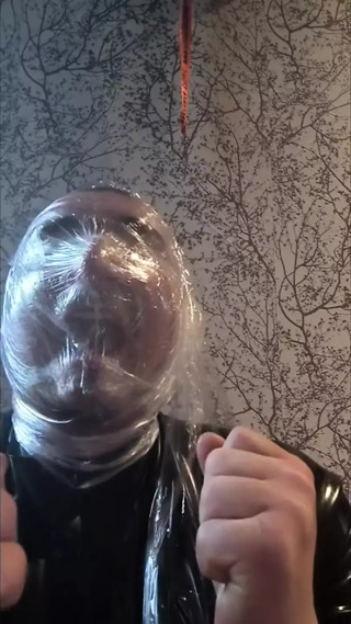 Breath play with cling film wearing latex catsuit thumbnail