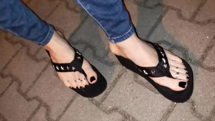 crossdressing on the street in sexy platform thongs and skinny leggings thumbnail