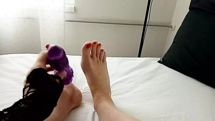 Milf tranny simulates a Footjob with a vibrator between her red painted toes