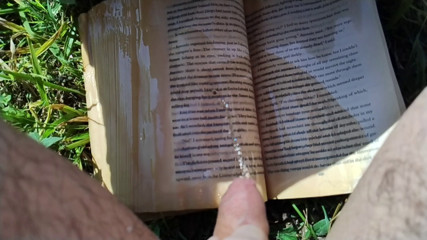 Pissing on a Book Outdoors (slow motion)
