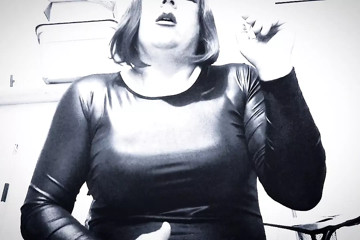 Samantha CD smoking VS120 in PVC dress and stroking her cock