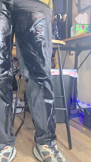 Wetting thick black pants standing in living room. thumbnail