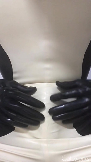 Catsuit handjob wearing latex sheath inside
