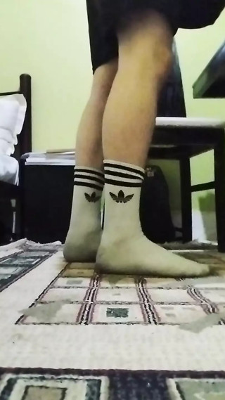 Cute twink showing his dirty white socks, while he listening to music and singing.