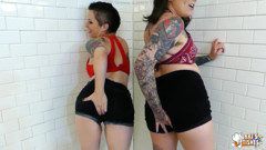 NIKKISFETISHES Two tattooed brunettes in lingerie pose together inside tiled bathroom